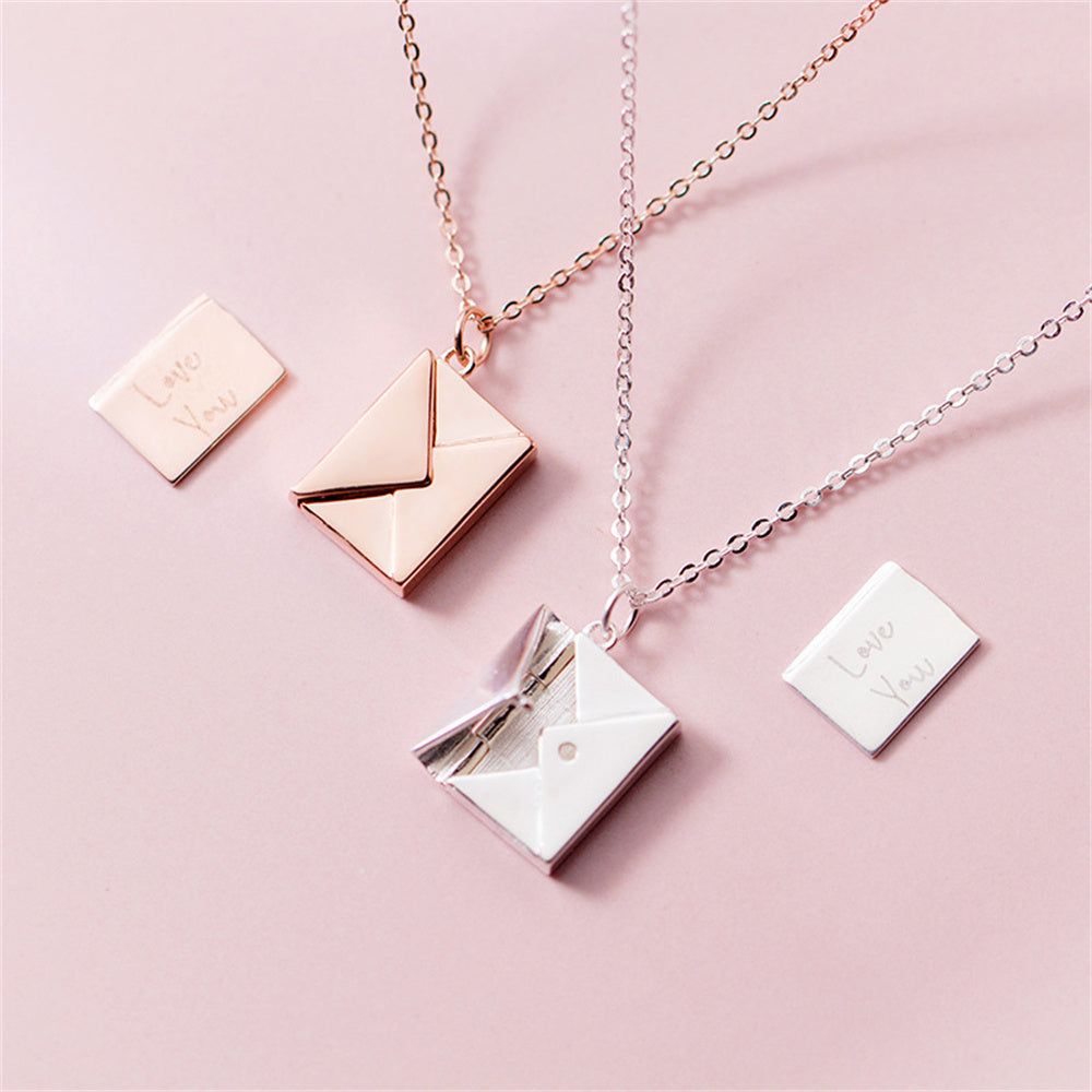 Necklace with envelope pendants on a pink background